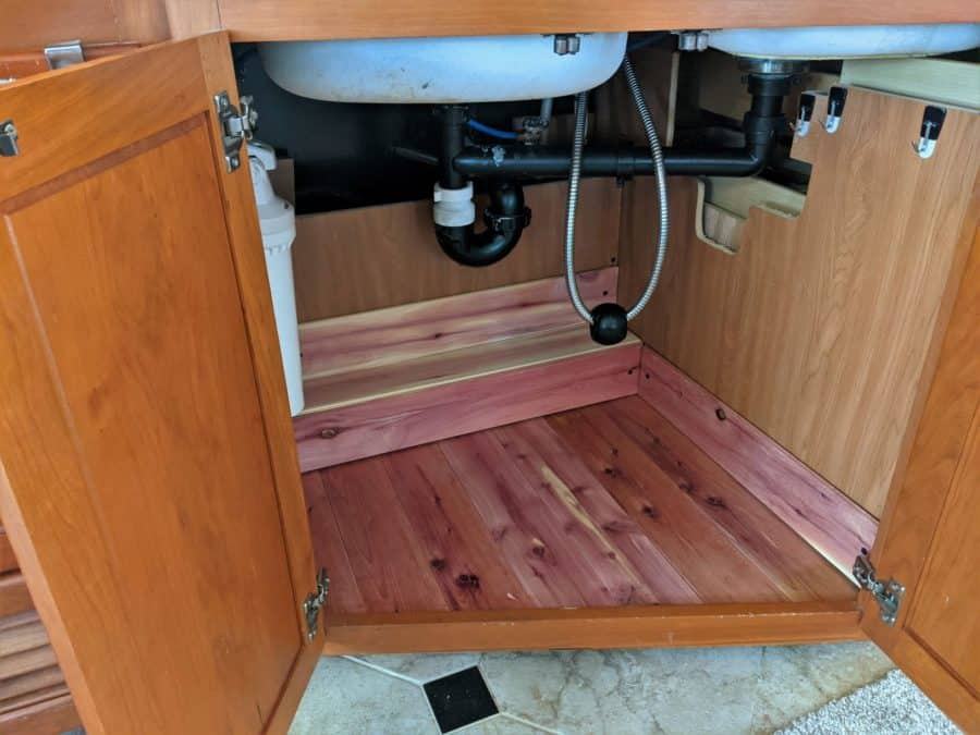 Under the kitchen sink, I removed the old carpet and replaced it with cedar closet lining.