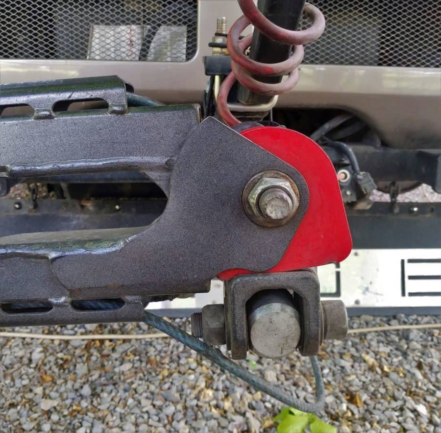 Tow bar yoke with spring-loaded storage latch in stored position.