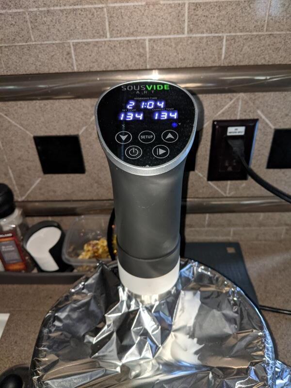 Sous Vide cooker in action. The temperature is 134 degrees Fahrenheit and the cooking time is 21 hours.