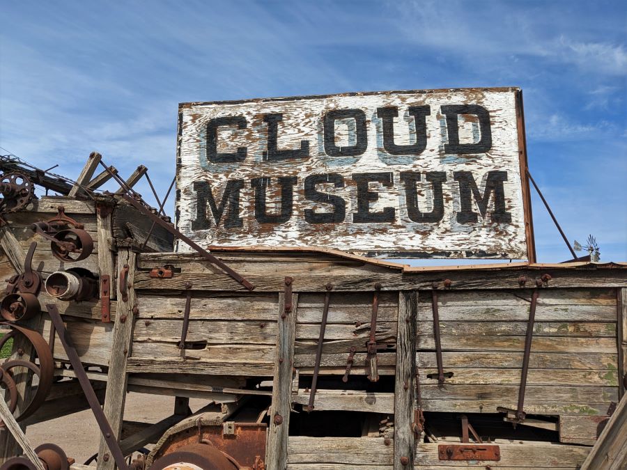 This sign for the Cloud Museum sits on a very old automatic thresher. It preceded the Combine by several years.