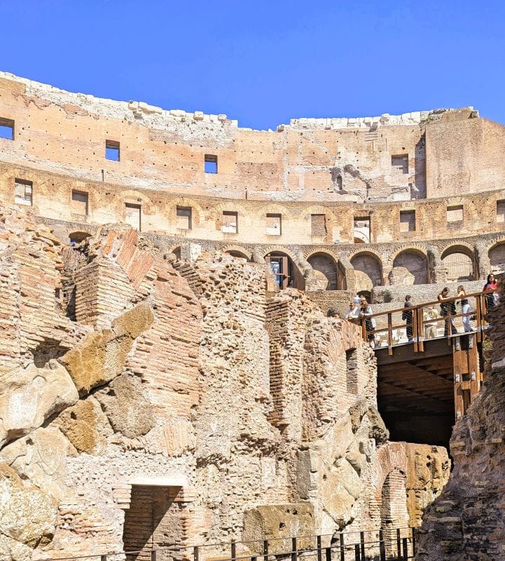 Photo looking up from the lowest level of the basement in the Colosseum. The people at left center of the photo are sanding on the rebuilt arena floor. Photos are from FoxRVTravel article "The Roman Colosseum."
