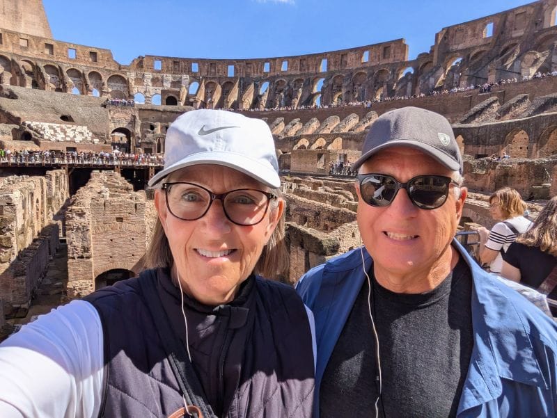 Tami and Scott standing opposite of the rebuilt platform at the Colosseum. Everything above the level of my sunglasses are the seating. Everything below my sunglasses is the basement. Photos are from FoxRVTravel article "The Roman Colosseum."