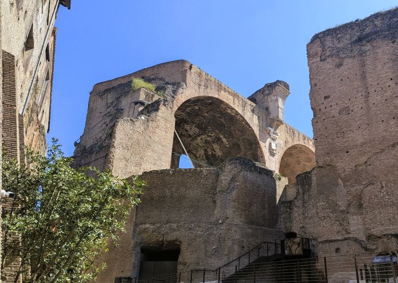 The arch is part of the three huge arches that was part of the The Basilica of Maxentius. At one time a statue of Constantine stood in under one of the arches. At the time of its construction, it was the largest building in the Forum, and the last Roman basilica built in the city. Photos are from the FoxRVTravel article “The Roman Forum.”