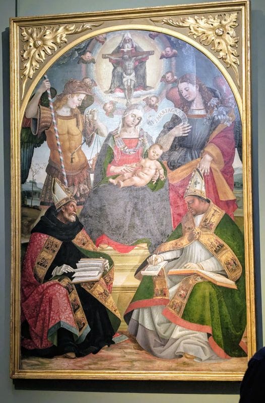 Luca Signorelli 1460 - 1523 The Trinity, the Madonna and Child, the Archangels Michael and Gabriel, St. Augustine and St. Athanasius of Alexandria c. 1510. Oil on wood Photo from FoxRVTravel article "Masterpiece paintings at the Uffizi Gallery" 