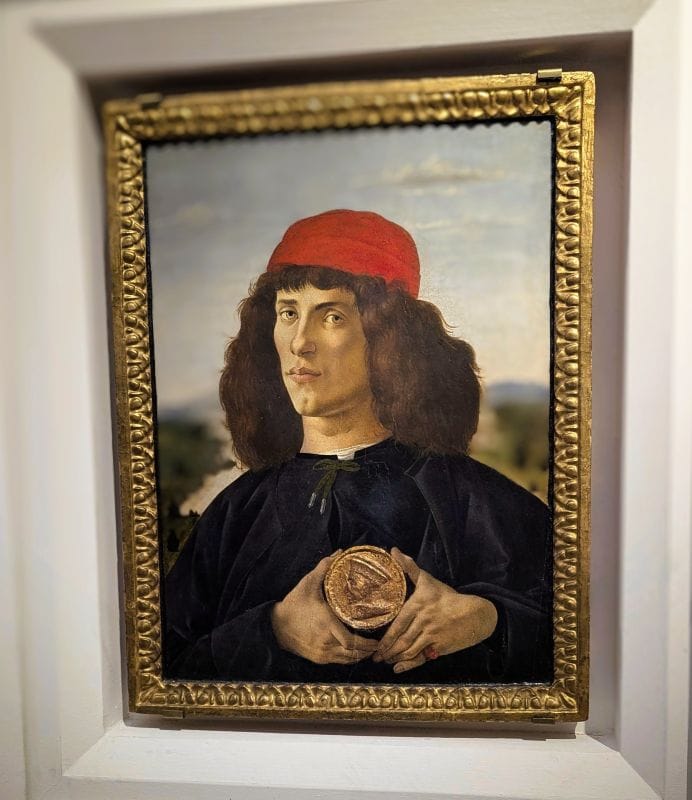 Sandro Botticelli (1445 – 1510) Portrait of a Young Man Holding a Medallion c. 1475 Tempera on wood Photo from FoxRVTravel article "Masterpiece paintings at the Uffizi Gallery" 