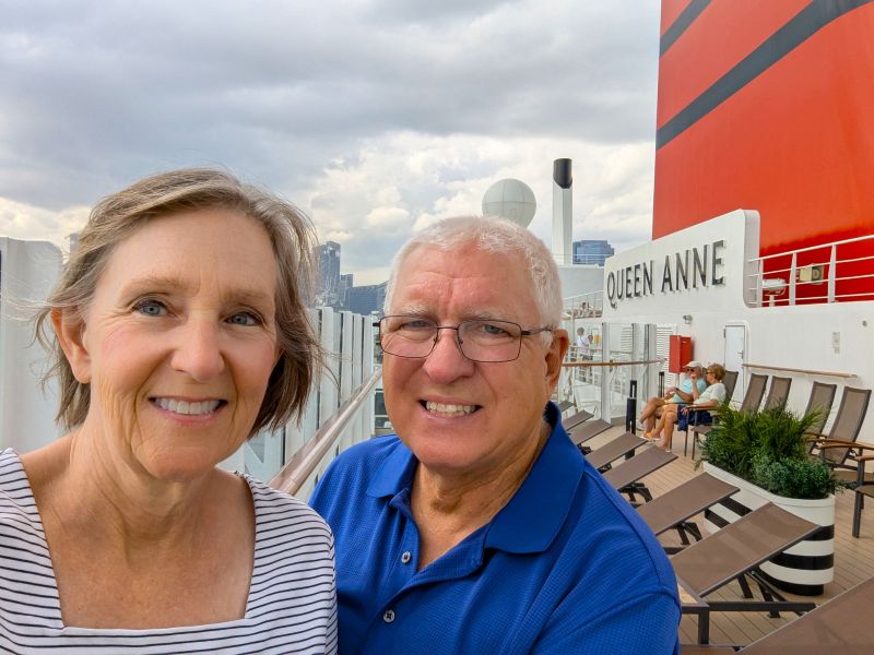 Scott and Tami on deck 12 near Hong Kong. The large red structure contains the stack where the engine exhaust gases are released.