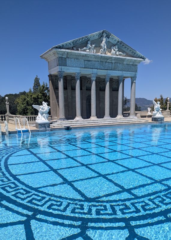 The pool at the Hearst Castle appears to be a Greek style. While the columns were built during the construction, many of the elements including the statue of Neptune at the top are original art pieces.