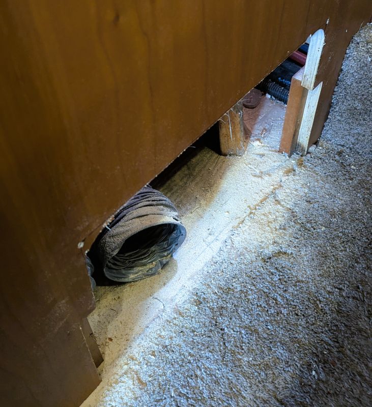 This is what my expanded access hole looks like. Eventually I was able to tuck the heating duct (there were two) away and get my arm in the hole while laying on the bed.