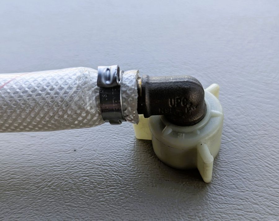 The hose and swivel fitting was attached to the mixing valve on the back of our shower.