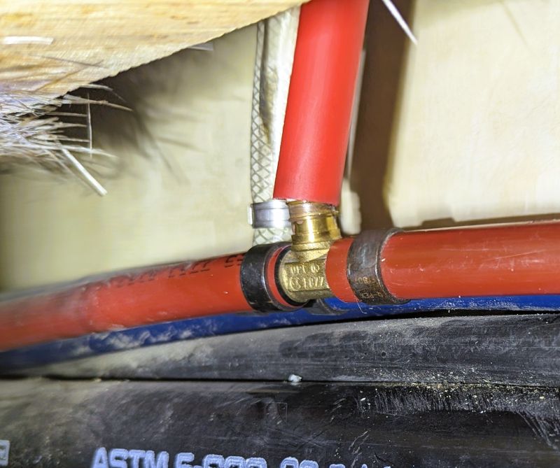 In this photo, you can see that I am trying to place the new PEX pipe over the fitting.