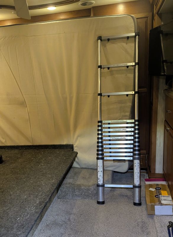 The mattress is against the cabinet doors and I am using my ladder to hold it upright.
