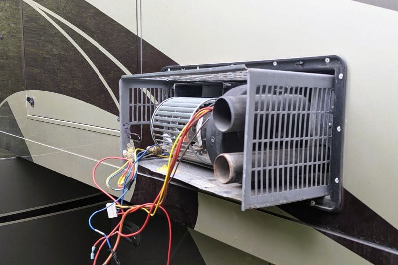 Winter started at the end of June. 12 This photo is a mistake I made trying to get to the problem. The grill should have remained inside the RV but instead I was removing it. I had to put the furnace back in the RV so I could remove only the working components and not the entire furnace.