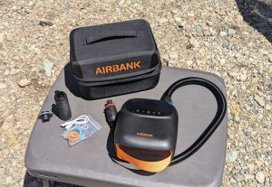 The AIRBANK PUFFER Pro Rechargeable Pump with hose attached and carrying/storage case.