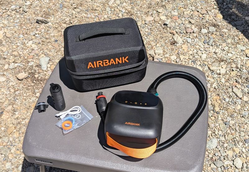 The AIRBANK PUFFER Pro Rechargeable Pump with hose attached and carrying/storage case.