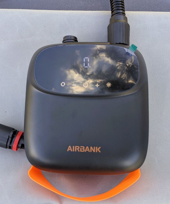 Our AIRBANK PUFFER Pro Rechargeable Pump with hose attached and orange carrying handle.